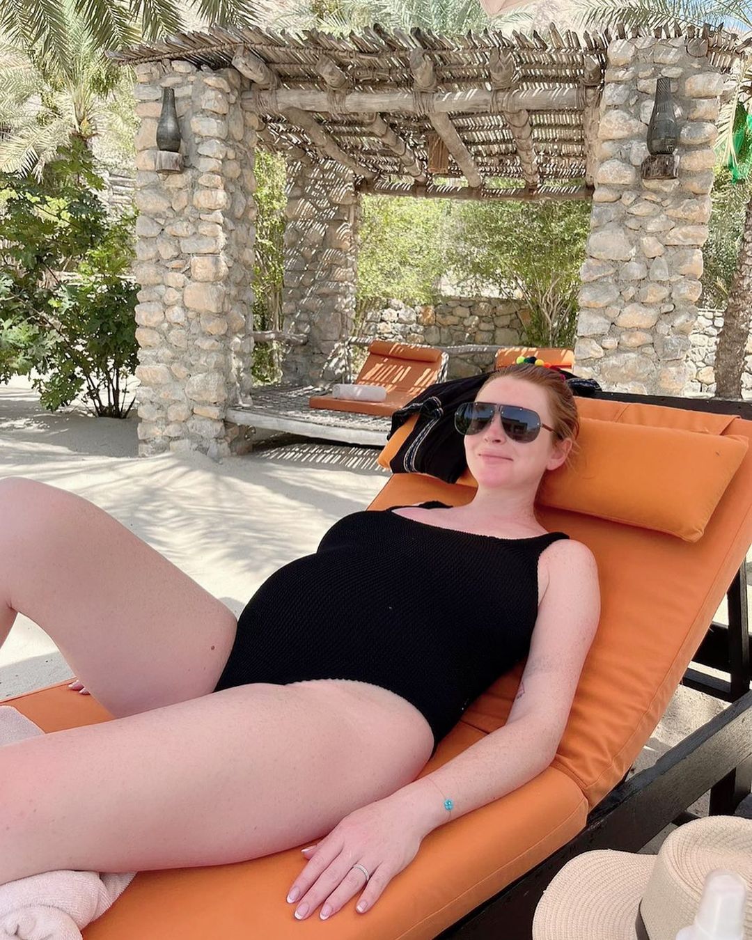 Lindsay Lohan Lays Back With Her Growing Bump!